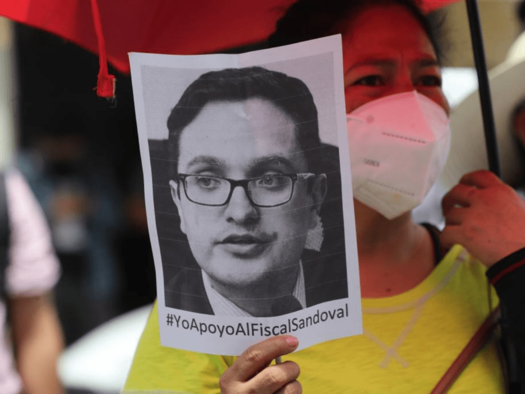 A protestor holds a flyer featuring an image of former public prosecutor Juan Sandoval. Juan became the people's champion for battling corruption in the government. | Photo courtesy of Juan Francisco Sandoval Alfaro