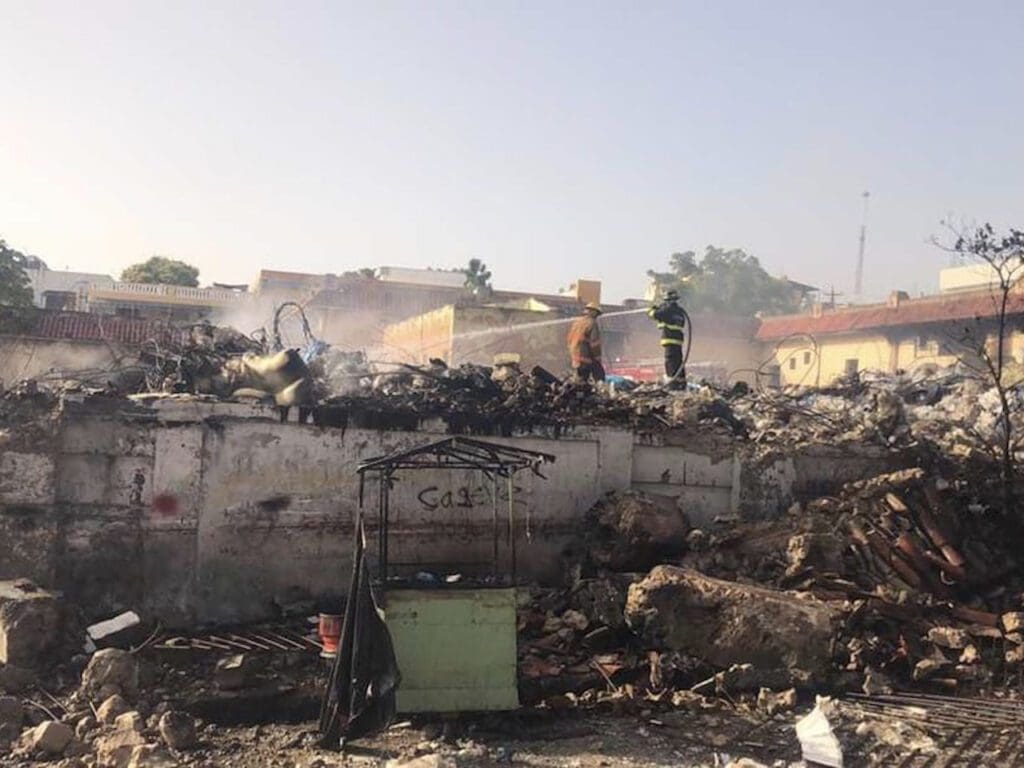 The wreckage of the explosion in a busy market in the Dominican Republic left dozens dead and injured, while the owner of Vidal Plast has been arrested.